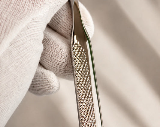 Cleaning textured stainless steel cutlery with a soft white cloth