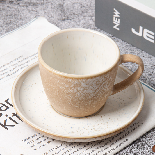 Ceramic cup and saucer on a newspaper background