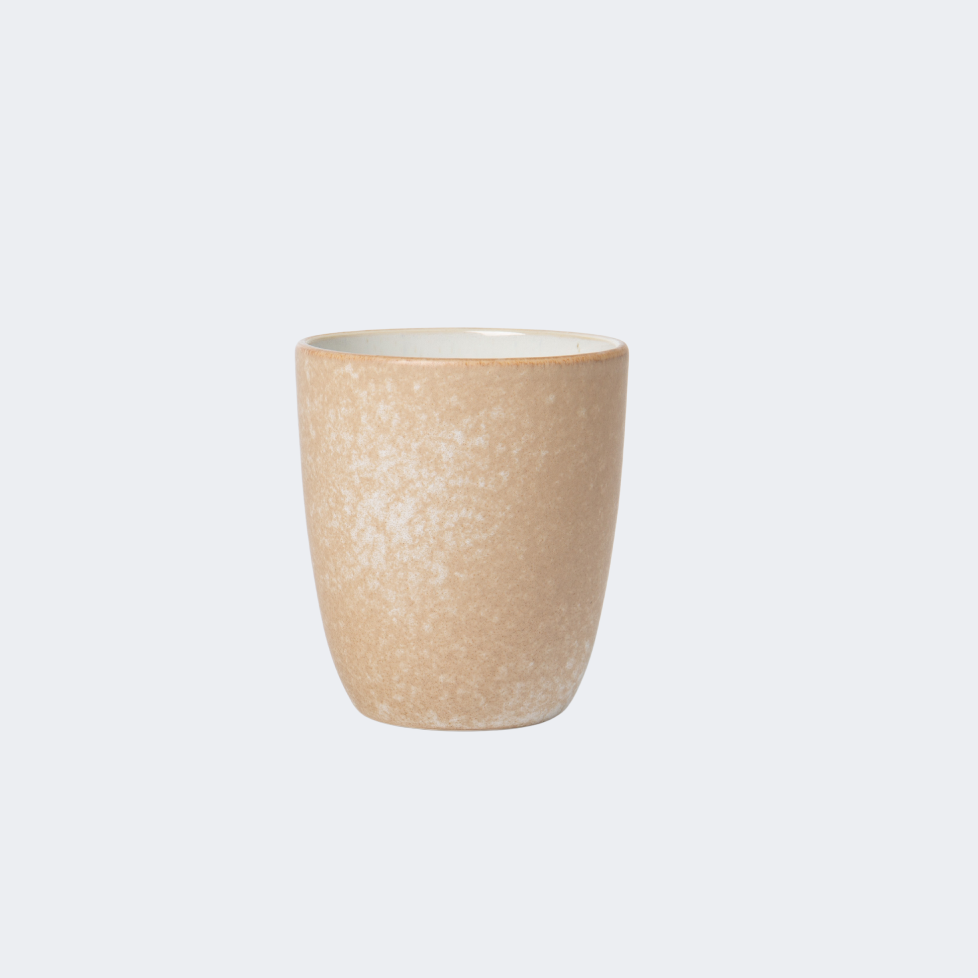 Beige ceramic cup on a light gray background