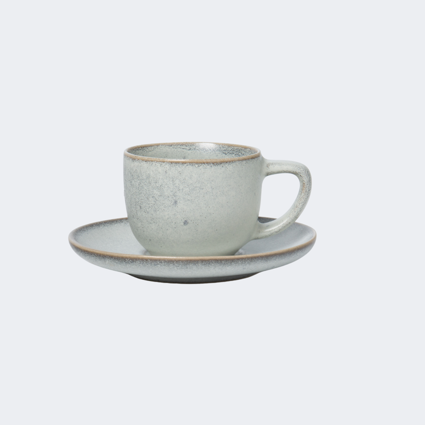 Ceramic cup and saucer set on a light gray background