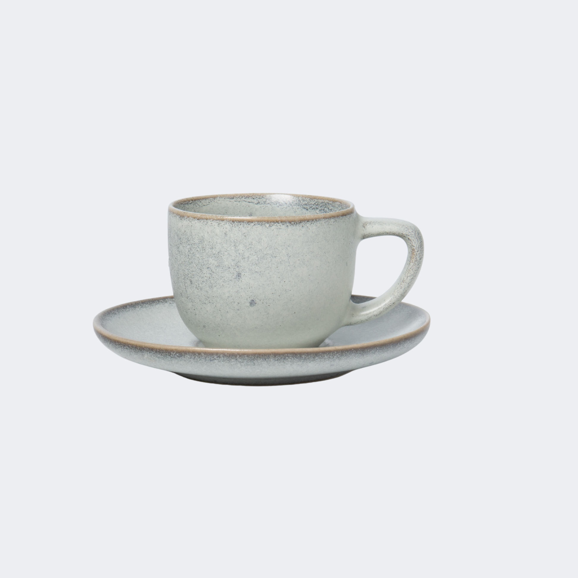 Ceramic cup and saucer set on a light gray background